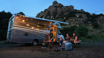 Friends sitting outside a motorhome, using an EcoFlow power pack