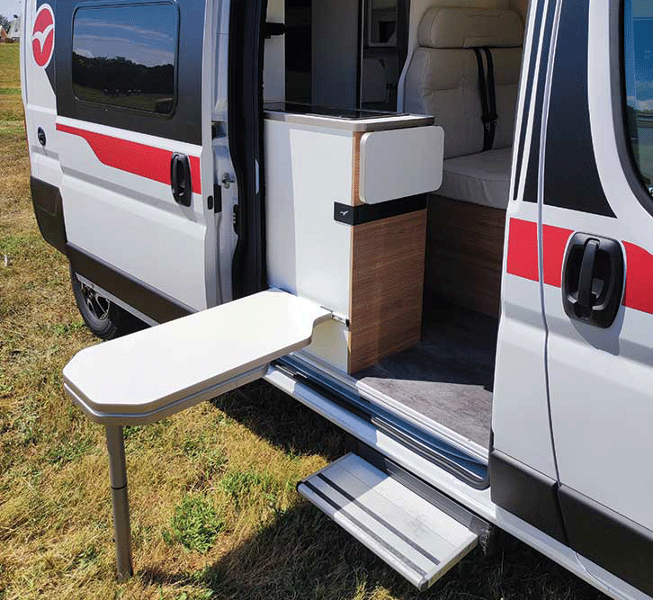 Dining table affixed to the side of a motorhome kitchen.