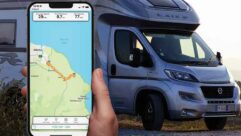 A tracker app on a phone with a motorhome in the background