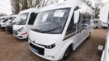 An A-class motorhome at a forecourt